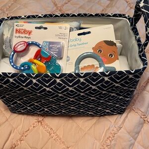 Baby gift basket, quilt, blanket, books and teething toys.